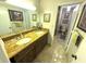 Bathroom featuring double sink vanity with granite countertop, large mirror and entry to shower and toilet at 100 Bluff View Dr # 502C, Belleair Bluffs, FL 33770