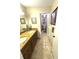 Bathroom featuring double sink vanity with granite countertop and view of separate toilet and shower area at 100 Bluff View Dr # 502C, Belleair Bluffs, FL 33770