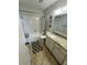 Full bathroom featuring a tub and shower combo, toilet, and vanity with decorative mirror at 100 Bluff View Dr # 502C, Belleair Bluffs, FL 33770