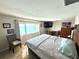Bedroom featuring a bed, waterfront views, and neutral decor at 100 Bluff View Dr # 502C, Belleair Bluffs, FL 33770