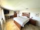 Bedroom with large bed, tile floors, and a view to the outside at 100 Bluff View Dr # 502C, Belleair Bluffs, FL 33770