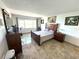 Bedroom featuring sleek tile flooring and a large window with natural light and exercise equipment at 100 Bluff View Dr # 502C, Belleair Bluffs, FL 33770