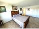 Bedroom features a stylish wood bed frame, neutral walls, and tiled floors at 100 Bluff View Dr # 502C, Belleair Bluffs, FL 33770
