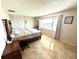 Bright bedroom with large window, tile flooring, and closet space at 100 Bluff View Dr # 502C, Belleair Bluffs, FL 33770