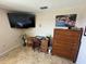 Bedroom featuring tiled floors, a mounted tv, and a desk with chair at 100 Bluff View Dr # 502C, Belleair Bluffs, FL 33770