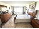 This bedroom has lots of space, a large window, and stylish dressers and decor at 100 Bluff View Dr # 502C, Belleair Bluffs, FL 33770