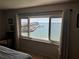 Bedroom view showcases serene waterfront views from a large window, creating a tranquil and inviting space at 100 Bluff View Dr # 502C, Belleair Bluffs, FL 33770