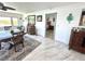 Dining area featuring a dining table, marble floors, and a view into the bedroom at 100 Bluff View Dr # 502C, Belleair Bluffs, FL 33770