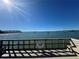 Waterfront dock with a view of the clear blue sky and sailboats in the water at 100 Bluff View Dr # 502C, Belleair Bluffs, FL 33770