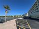 Exterior shot of a waterfront condo building with palm trees and a waterfront view at 100 Bluff View Dr # 502C, Belleair Bluffs, FL 33770