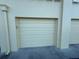 Exterior view of a garage door; neutral-colored and functional at 100 Bluff View Dr # 502C, Belleair Bluffs, FL 33770