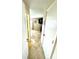 Hallway view showcases neutral tile flooring and decor leading into the living space at 100 Bluff View Dr # 502C, Belleair Bluffs, FL 33770