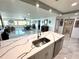 Well-lit open layout from kitchen island into the living room at 100 Bluff View Dr # 502C, Belleair Bluffs, FL 33770