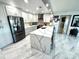 Modern kitchen features white cabinets, stainless steel appliances, and a waterfall island with stylish countertops at 100 Bluff View Dr # 502C, Belleair Bluffs, FL 33770
