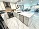 Modern kitchen with a waterfall island, stainless steel appliances, and views to the living spaces at 100 Bluff View Dr # 502C, Belleair Bluffs, FL 33770