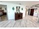 Hallway with hardwood floor leads into bedroom and living room at 100 Bluff View Dr # 502C, Belleair Bluffs, FL 33770