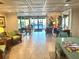 Condo complex lobby featuring seating areas, tiled floors, and access to the outdoors at 100 Bluff View Dr # 502C, Belleair Bluffs, FL 33770