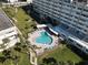 Aerial view of a resort-style pool at a luxury condo community, lushly landscaped at 100 Bluff View Dr # 502C, Belleair Bluffs, FL 33770