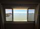 Framed window view of a serene bay with bridge and sailboats on the water at 100 Bluff View Dr # 502C, Belleair Bluffs, FL 33770