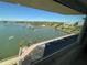 Expansive water view from a condo featuring a dock, marina, and palm trees under a clear sky at 100 Bluff View Dr # 502C, Belleair Bluffs, FL 33770