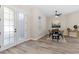 Dining room featuring wood floors, modern light fixture, and view of backyard at 11234 Rivers Bluff Cir, Lakewood Ranch, FL 34202