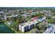 Aerial view of condo building with community pool and beautiful landscaping at 11485 Oakhurst Rd # A202, Largo, FL 33774