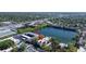 Aerial view of condo building with lake view, pool, tennis court, and lush landscaping at 11485 Oakhurst Rd # A202, Largo, FL 33774