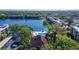Aerial view of the community, the pool and community center with water views surrounded by lush landscaping at 11485 Oakhurst Rd # A202, Largo, FL 33774