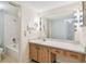 Well-lit bathroom vanity with a spacious countertop, ample cabinet storage, and a large mirror at 11485 Oakhurst Rd # A202, Largo, FL 33774