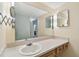 Bright bathroom vanity featuring a sink, vanity mirror, and lighting at 11485 Oakhurst Rd # A202, Largo, FL 33774