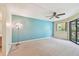 This room features a ceiling fan and a large sliding door leading to the screened-in patio at 11485 Oakhurst Rd # A202, Largo, FL 33774