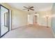 This bedroom features a ceiling fan, closet, and a sliding door leading to the screened-in patio at 11485 Oakhurst Rd # A202, Largo, FL 33774