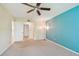 This room features a ceiling fan and two doorways and large blue wall at 11485 Oakhurst Rd # A202, Largo, FL 33774