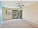 The bedroom features a ceiling fan, a sliding door and window with natural light at 11485 Oakhurst Rd # A202, Largo, FL 33774