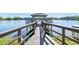 A wooden dock extends over a calm lake, inviting residents to enjoy waterfront living and scenic views at 11485 Oakhurst Rd # A202, Largo, FL 33774