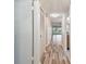 Hallway view showing neutral walls and hardwood floors at 11485 Oakhurst Rd # A202, Largo, FL 33774