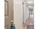 Hallway view highlighting hardwood floors and a modern lighting fixture at 11485 Oakhurst Rd # A202, Largo, FL 33774