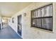 Hallway view featuring exterior door and window with white curtain at 11485 Oakhurst Rd # A202, Largo, FL 33774