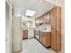 Bright kitchen area with white appliances and overhead lighting at 11485 Oakhurst Rd # A202, Largo, FL 33774