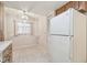 Bright kitchen area with white refrigerator and view of chandelier lighting at 11485 Oakhurst Rd # A202, Largo, FL 33774