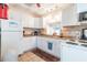 Bright kitchen featuring white cabinetry and essential appliances at 11485 Oakhurst Rd # A202, Largo, FL 33774