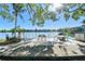 A lakefront seating area with tables and chairs, providing a relaxing outdoor dining experience with water views at 11485 Oakhurst Rd # A202, Largo, FL 33774