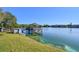 Tranquil lake view with a gazebo and dock; a perfect community amenity for relaxation and enjoying nature at 11485 Oakhurst Rd # A202, Largo, FL 33774