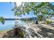 A lakefront seating area with tables and chairs, providing a relaxing outdoor dining experience with water views at 11485 Oakhurst Rd # A202, Largo, FL 33774