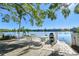 A lakefront seating area with tables and chairs, providing a relaxing outdoor dining experience with water views at 11485 Oakhurst Rd # A202, Largo, FL 33774