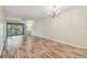 Bright living room featuring wood floors and a sliding glass door to the balcony at 11485 Oakhurst Rd # A202, Largo, FL 33774