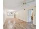 Open living room with view to the kitchen and entry to the bathroom at 11485 Oakhurst Rd # A202, Largo, FL 33774