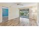 Living room with an open sliding glass door leading to the balcony at 11485 Oakhurst Rd # A202, Largo, FL 33774