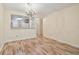 Open-concept living and dining area with hardwood floors and a view into the kitchen at 11485 Oakhurst Rd # A202, Largo, FL 33774