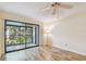 Bright living room with sliding glass doors to a balcony with nature views at 11485 Oakhurst Rd # A202, Largo, FL 33774